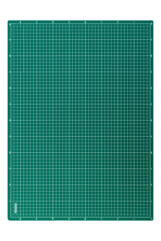 Green desk mat with white grid and rulers